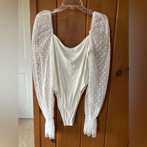 white bodysuit with mesh polkadots sleeves